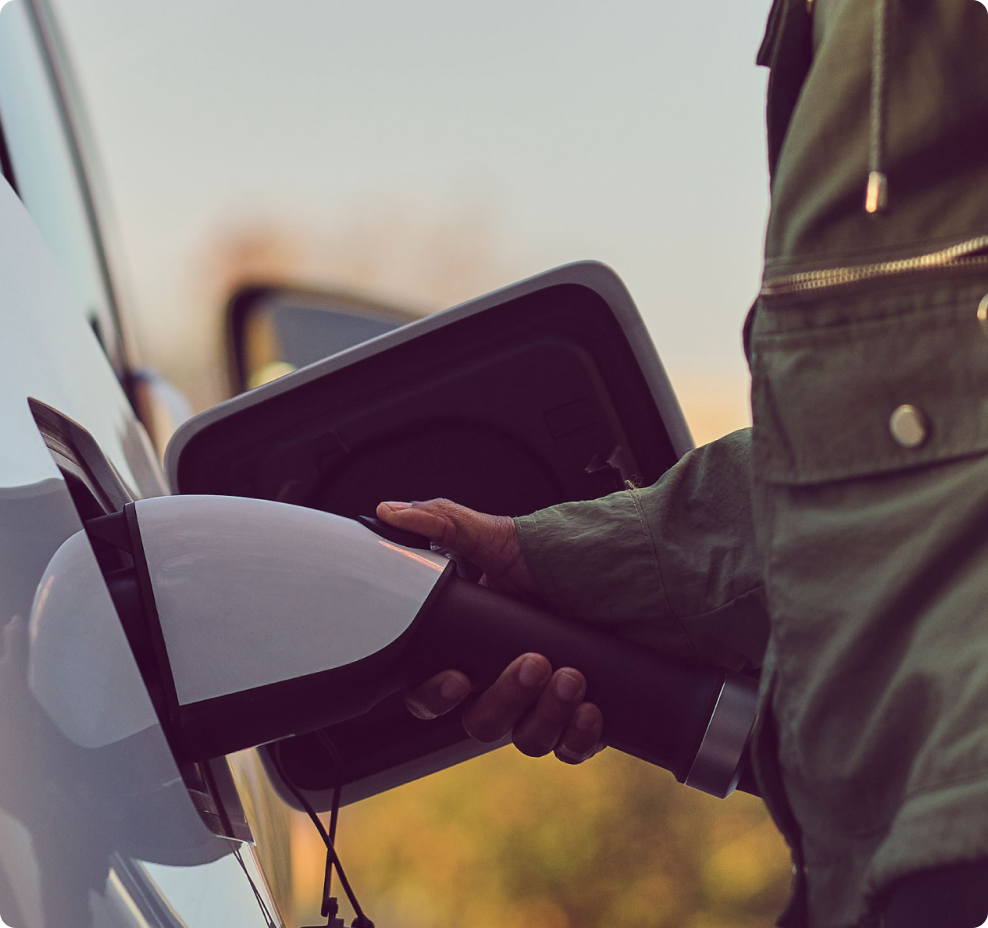 Closeup of a person fueling an electric vehicle.