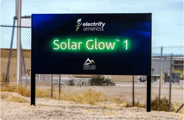 A picture of the renewable energy farm. A sign says Solar Glow 1.