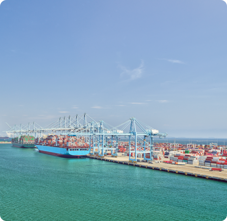 Loading dock with shipping containers on ships