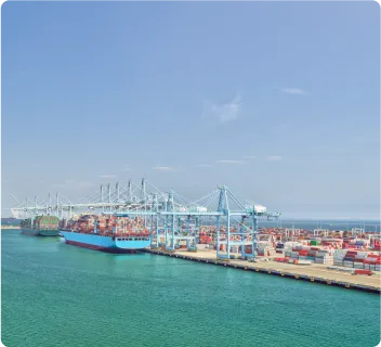 Loading dock with shipping containers on ships