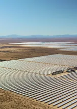 An aerial view of a large field full of solar panels.